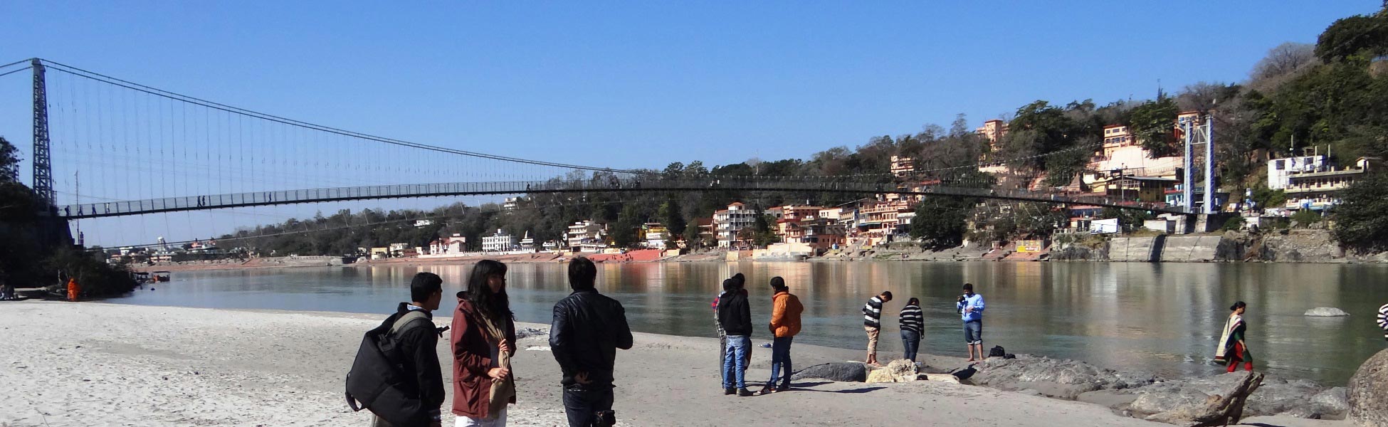 Trisna Films camera crew and production team managing a documentary shoot for the Eight Limbs of Yoga on the sandy banks of the Ganges River near the Ram Jhula suspension bridge in Rishikesh, Uttarakhand, India. film shooting locations in Barbados, video shooting locations in Barbados, tv shooting locations in Barbados, shooting locations in Barbados