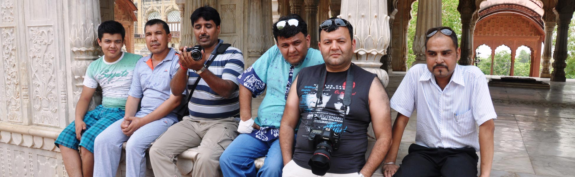 Joint Indo-Uzbek music video cast and crew sitting on the white marble pavilion terrace of Moosi Maharani Ki Chhatri in Alwar, Rajasthan during a line production shoot by Trisna Films. film shooting locations in Bhadrak, video shooting locations in Bhadrak, tv shooting locations in Bhadrak, shooting locations in Bhadrak