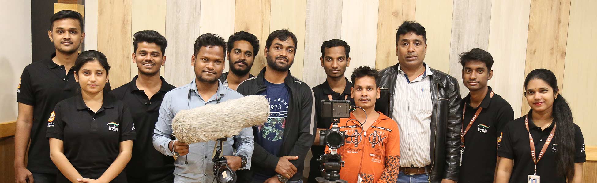Trisna Films crew and team members on location at Centurion University, Jatni, Bhubaneswar campus in Odisha, India, during the filming of the Dassault Systemes documentary 'Living Heritage.' The group includes technicians with sound and camera equipment. filmmaking workshop in india, filmmaking workshop in delhi, filmmaking workshop in mumbai, filmmaking workshop in pune, filmmaking workshop in sonipat, filmmaking workshop in begusarai, cinematography workshop in india, cinematography workshop in delhi, cinematography workshop in mumbai, cinematography workshop in pune, cinematography workshop in sonipat, cinematography workshop in begusarai, camera workshop in india, camera workshop in delhi, camera workshop in mumbai, camera workshop in pune, camera workshop in sonipat, camera workshop in begusarai, editing workshop in india, editing workshop in delhi, editing workshop in mumbai, editing workshop in pune, editing workshop in sonipat, editing workshop in begusarai, vfx workshop in india, vfx workshop in Delhi, vfx workshop in mumbai, vfx workshop in pune, vfx workshop in sonipat, vfx workshop in begusarai, animation workshop in india, animation workshop in Delhi, animation workshop in mumbai, animation workshop in pune, animation workshop in sonipat, animation workshop in begusarai, photography workshop in india, photography workshop in delhi, photography workshop in mumbai, photography workshop in pune, photography workshop in sonipat, photography workshop in begusarai, direction workshop in india, direction workshop in delhi, direction workshop in mumbai, direction workshop in pune, direction workshop in sonipat, direction workshop in begusarai, script writing workshop in india, script writing workshop in delhi, script writing workshop in mumbai, script writing workshop in pune, script writing workshop in sonipat, script writing workshop in begusarai