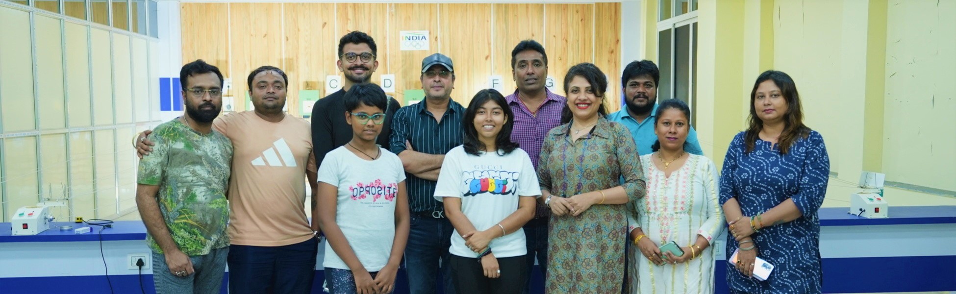 Group photo of the Trisna Films crew at a shooting range facility in Kolkata, West Bengal, India, during the documentary film production for IOC Young Leader Rishav Bhowmik. music video shooting locations in india