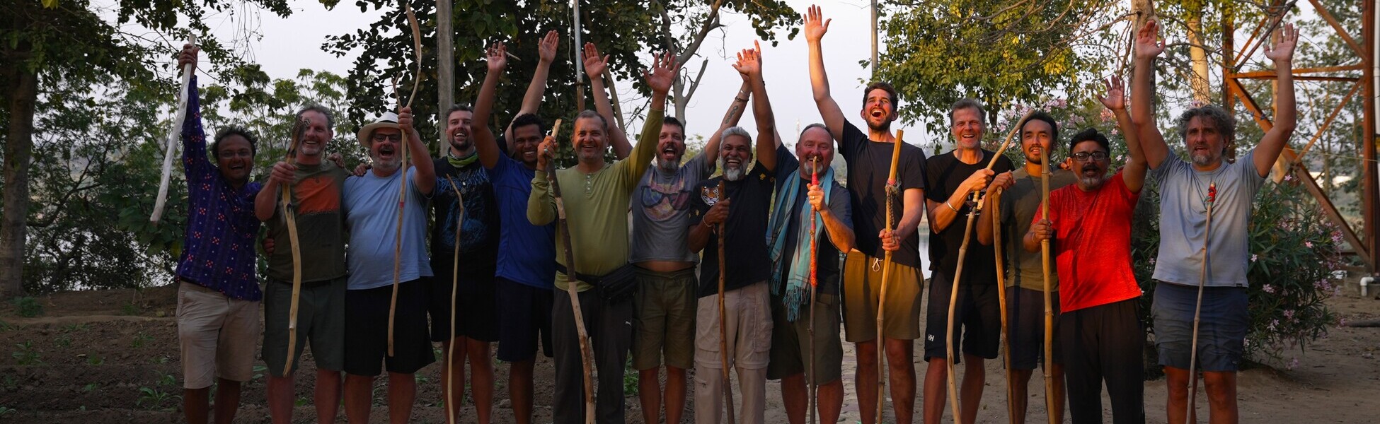 Twelve participants and two spiritual guides of the documentary film 'The New Man' celebrate with walking sticks on the banks of the Narmada River in India after completing their journey. film shooting locations in Andijan, video shooting locations in Andijan, tv shooting locations in Andijan, shooting locations in Andijan