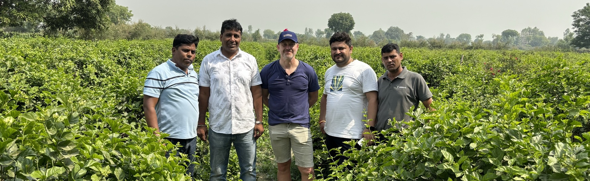 Director Mark Limburg (center, in blue cap) stands with four members of the Trisna Films local production crew in a lush green field in Kannauj, Uttar Pradesh, India, during the filming of the 'Rain' documentary. film production house in india, film production house in Delhi, film production house in mumbai, film production house in pune, film production house in sonipat, film production house in begusarai, video production house in india, video production house in Delhi, video production house in mumbai, video production house in pune, video production house in sonipat, video production house in begusarai, tv production house in india, tv production house in delhi, tv production house in mumbai, tv production house in pune, tv production house in sonipat, tv production house in begusarai, production house in india, production house in delhi, production house in mumbai, production house in pune, production house in sonipat, production house in begusarai, film production company in india, film production company in delhi, film production company in mumbai, film production company in pune, film production company in sonipat, film production company in begusarai, video production company in india, video production company in delhi, video production company in mumbai, video production company in pune, video production company in sonipat, video production company in begusarai, tv production company in india, tv production company in delhi, tv production company in mumbai, tv production company in pune, tv production company in sonipat, tv production company in begusarai, production company in india, production company in delhi, production company in mumbai, production company in pune, production company in sonipat, production company in begusarai