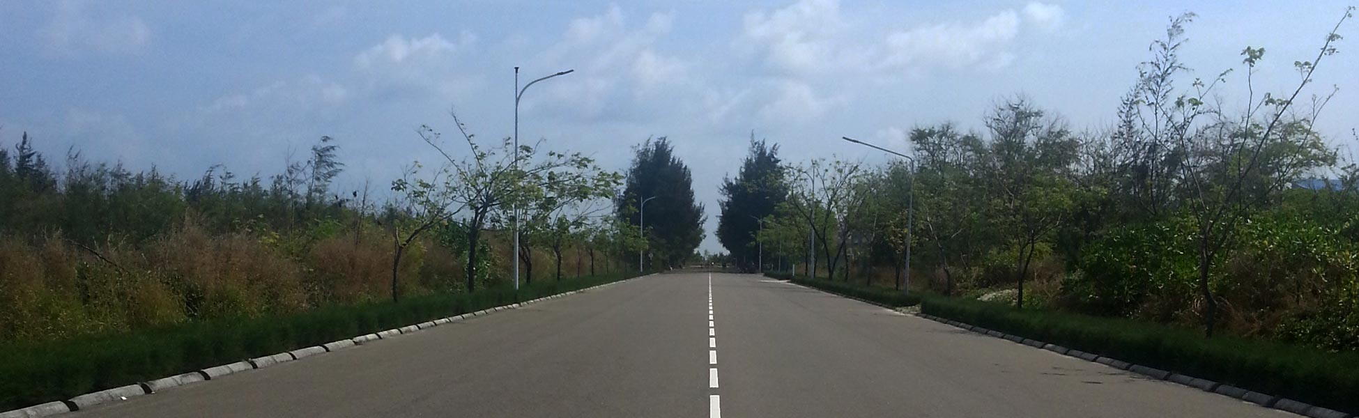 A perfectly symmetrical wide-angle shot of a modern asphalt road in Hulhumalé Phase 2, Maldives. Captured by Trisna Films®, this location features leading lines, tropical greenery, and clean minimalist infrastructure ideal for automotive or lifestyle cinematography. film production house in Araria, video production house in Araria, tv production house in Araria, production house in Araria, film production company in Araria, video production company in Araria, tv production company in Araria, production company in Araria