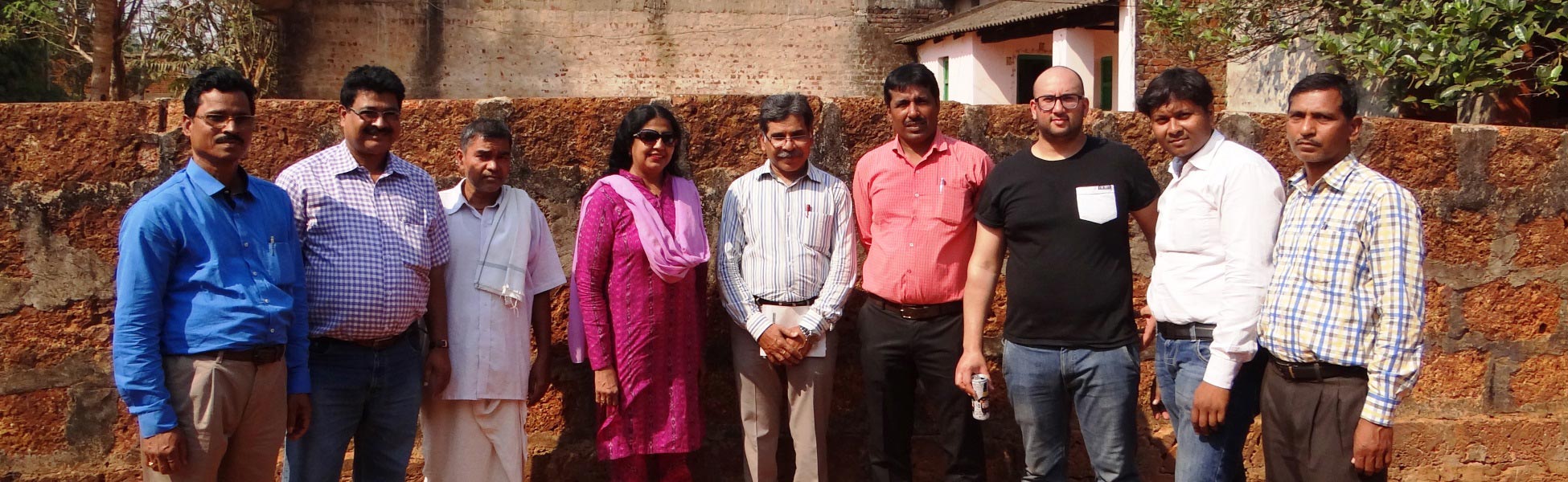 Group photo of the British and Indian film production crew standing against a traditional stone wall in Odisha, India, during the shoot for the Odisha Tourism CNN television campaign. film production house in Bhilwara, video production house in Bhilwara, tv production house in Bhilwara, production house in Bhilwara, film production company in Bhilwara, video production company in Bhilwara, tv production company in Bhilwara, production company in Bhilwara