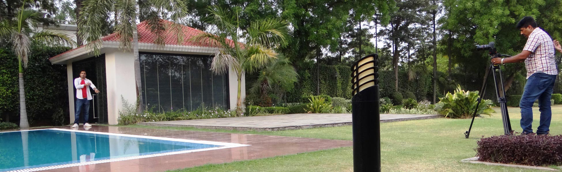 Trisna Films® production crew filming a music video on location in New Delhi, India; featuring a videographer with a tripod-mounted camera capturing talent by a luxury poolside villa. Fixer in Buenos Aires, fixer in Catamarca, fixer in Chaco, fixer in Chubut, fixer in Córdoba, fixer in Corrientes, fixer in Entre Ríos, fixer in Formosa, fixer in Jujuy, fixer in La Pampa, fixer in La Rioja, fixer in Mendoza, fixer in Misiones, fixer in Neuquén, fixer in Río Negro, fixer in Salta, fixer in San Juan, fixer in San Luis, fixer in Santa Cruz, fixer in Santa Fe, fixer in Santiago del Estero, fixer in Tierra del Fuego, Antártida e Islas del Atlántico Sur, fixer in Tucumán. Line producer in Buenos Aires, line producer in Catamarca, line producer in Chaco, line producer in Chubut, line producer in Córdoba, line producer in Corrientes, line producer in Entre Ríos, line producer in Formosa, line producer in Jujuy, line producer in La Pampa, line producer in La Rioja, line producer in Mendoza, line producer in Misiones, line producer in Neuquén, line producer in Río Negro, line producer in Salta, line producer in San Juan, line producer in San Luis, line producer in Santa Cruz, line producer in Santa Fe, line producer in Santiago del Estero, line producer in Tierra del Fuego, Antártida e Islas del Atlántico Sur, line producer in Tucumán.