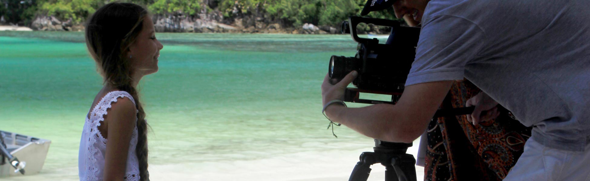Trisna Films® professional crew and cinematographer filming a music video on a tropical beach in Seychelles, demonstrating expert island production logistics. film shooting locations in india, film shooting locations in assam, film shooting locations in guwahati, video shooting locations in india, video shooting locations in assam, video shooting locations in guwahati, tv shooting locations in india, tv shooting locations in assam, tv shooting locations in guwahati, shooting locations in india, shooting locations in assam, shooting locations in guwahati