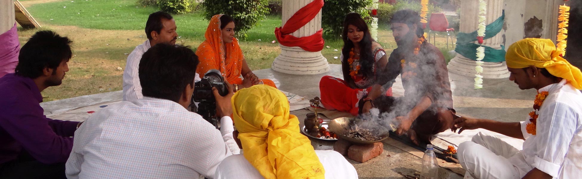 Film crew and actors on the set of 'Andhvishwas' short film in Delhi, India, capturing a traditional ritual scene with a havan fire and professional camera equipment. film shooting locations in Azerbaijan, film shooting locations in Baku, video shooting locations in Azerbaijan, video shooting locations in Baku, tv shooting locations in Azerbaijan, tv shooting locations in Baku, shooting locations in Azerbaijan, shooting locations in Baku