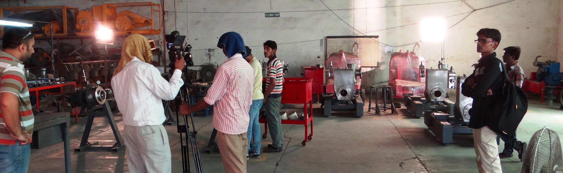 Professional video production crew filming a corporate documentary inside an industrial manufacturing factory assembly shop in Ludhiana, Punjab, featuring cameras, lighting equipment, and machinery. film production house in Balangir, video production house in Balangir, tv production house in Balangir, production house in Balangir, film production company in Balangir, video production company in Balangir, tv production company in Balangir, production company in Balangir